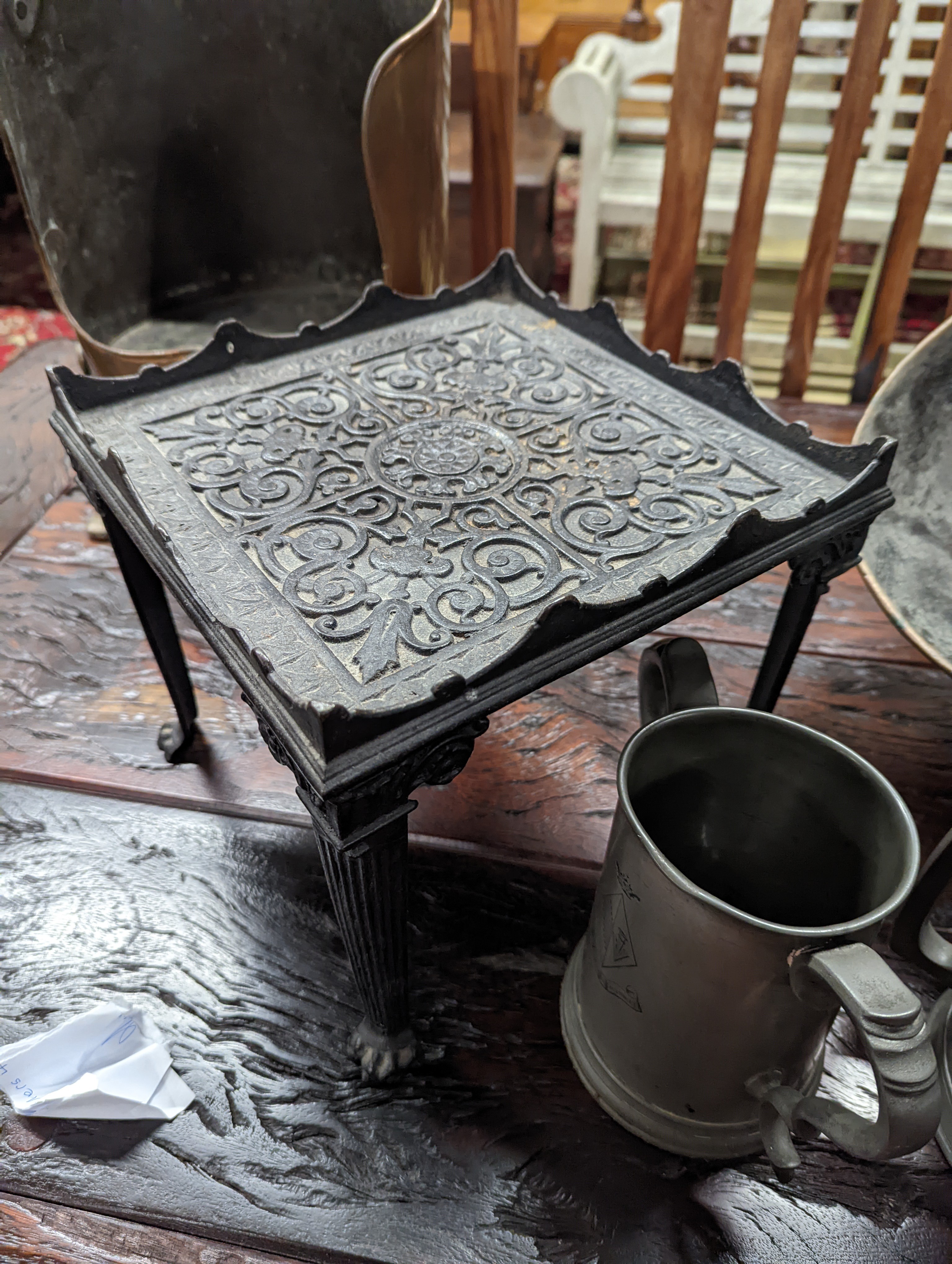 A Victorian copper coal scuttle, a square cast iron trivet, pewter items etc.